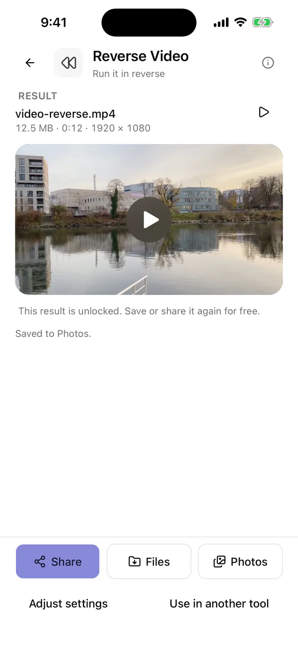 Vauli result screen in the iPhone Simulator for the reversed sample clip, showing the file name, the size, length and dimensions line, and the Share, Files and Photos buttons, Adjust settings and Use in another tool
